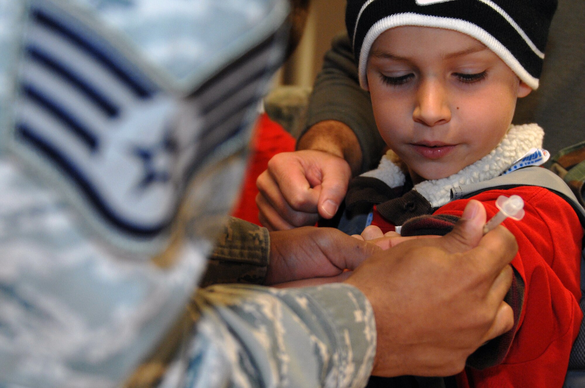 WHITEMAN AIR FORCE BASE, Mo. -- A child receives immunizations while out-processing during Operation Spirit April 16, 2011. Operation Spirit is hosted once a year to show military children a piece of what their parents might experience through a deployment.  (U.S. Air Force photo by Airman 1st Class Cody H. Ramirez)
