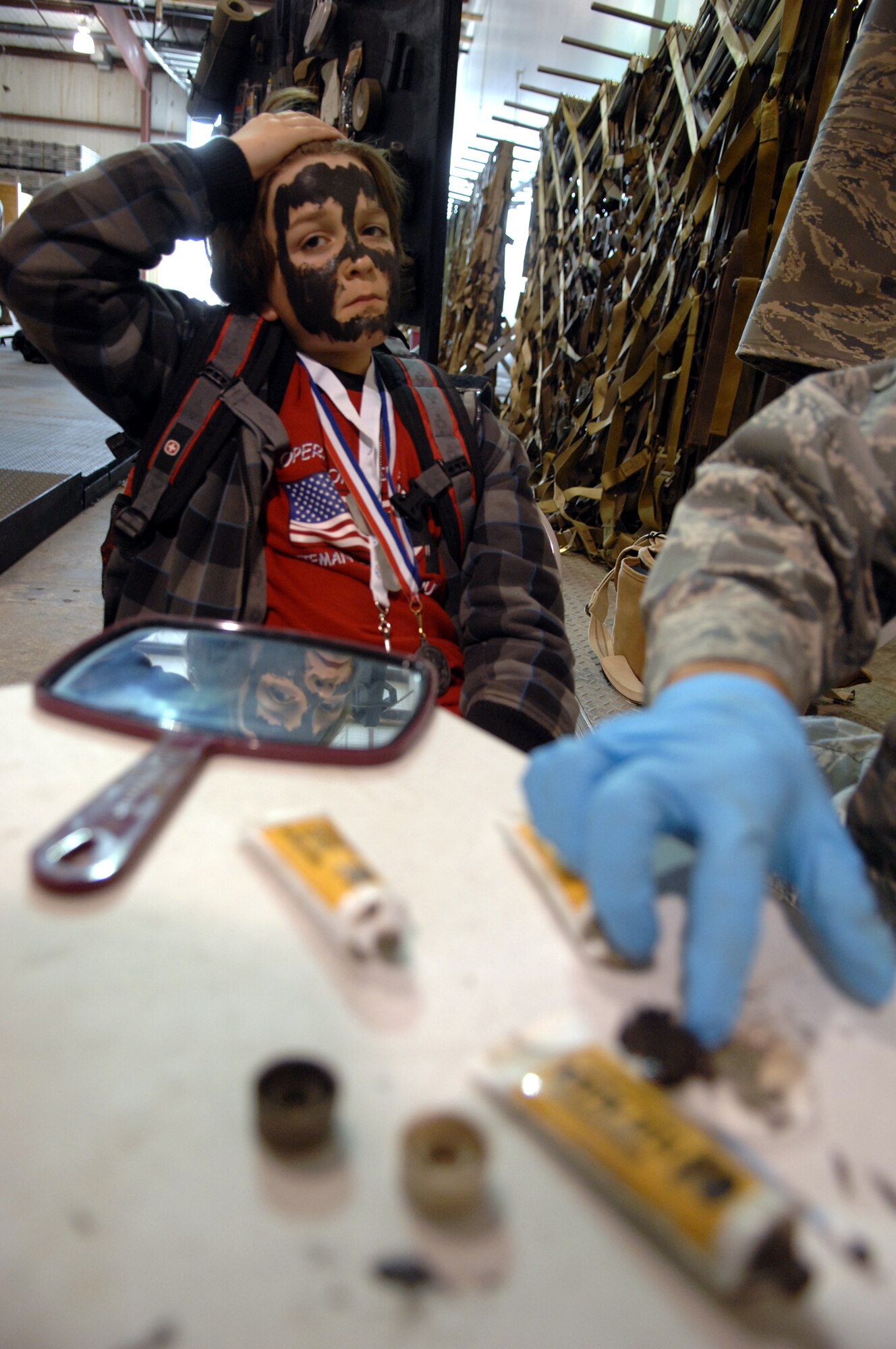 WHITEMAN AIR FORCE BASE, Mo. -- Tanner Tipton, son of Tech. Sgt. Nikole Tipton, 509th Force Support Squadron, gets his face painted during Operation Spirit April 16, 2011. Operation Spirit is hosted once a year to show military children a piece of what their parents might experience through a deployment.  (U.S. Air Force photo by Airman 1st Class Cody H. Ramirez)