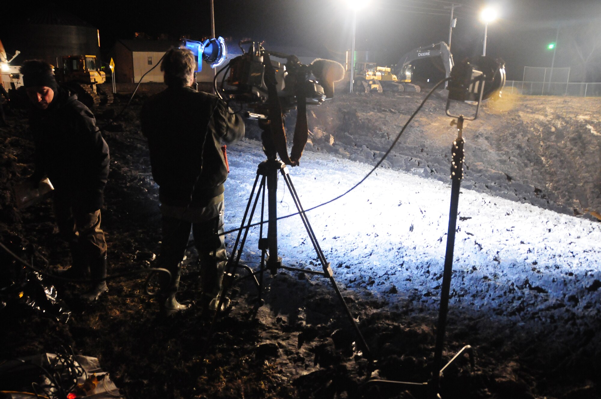 An ABC news crew records a live feed for Good Morning America's story on the 'Hole of Hope', in Georgetown, Minn. April 13, 2011.  Barbara Pinto, a news correspondent for ABC, reported from within the baseball field turned crater about how the town sacrificed the soil for levees to protect from Red River flooding in Minnesota.  (U.S. Air Force photo by Tech. Sgt. Brett R. Ewald)