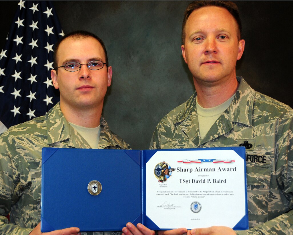 NIAGARA FALLS AIR RESERVE STATION, N.Y- Technical Sgt. David Baird (left), chief of personnel employment, 914th Force Support Squadron accepts the "Sharp Airman" coin and certificate from Chief Master Sgt. Scott Goetze, superintendant, 914th Maintenance Operations Flight.  The Chief's group recognized Baird from the 914th Force Support Squadron, during the April UTA.  (U.S. Air Force Reserve photo by Peter Borys)