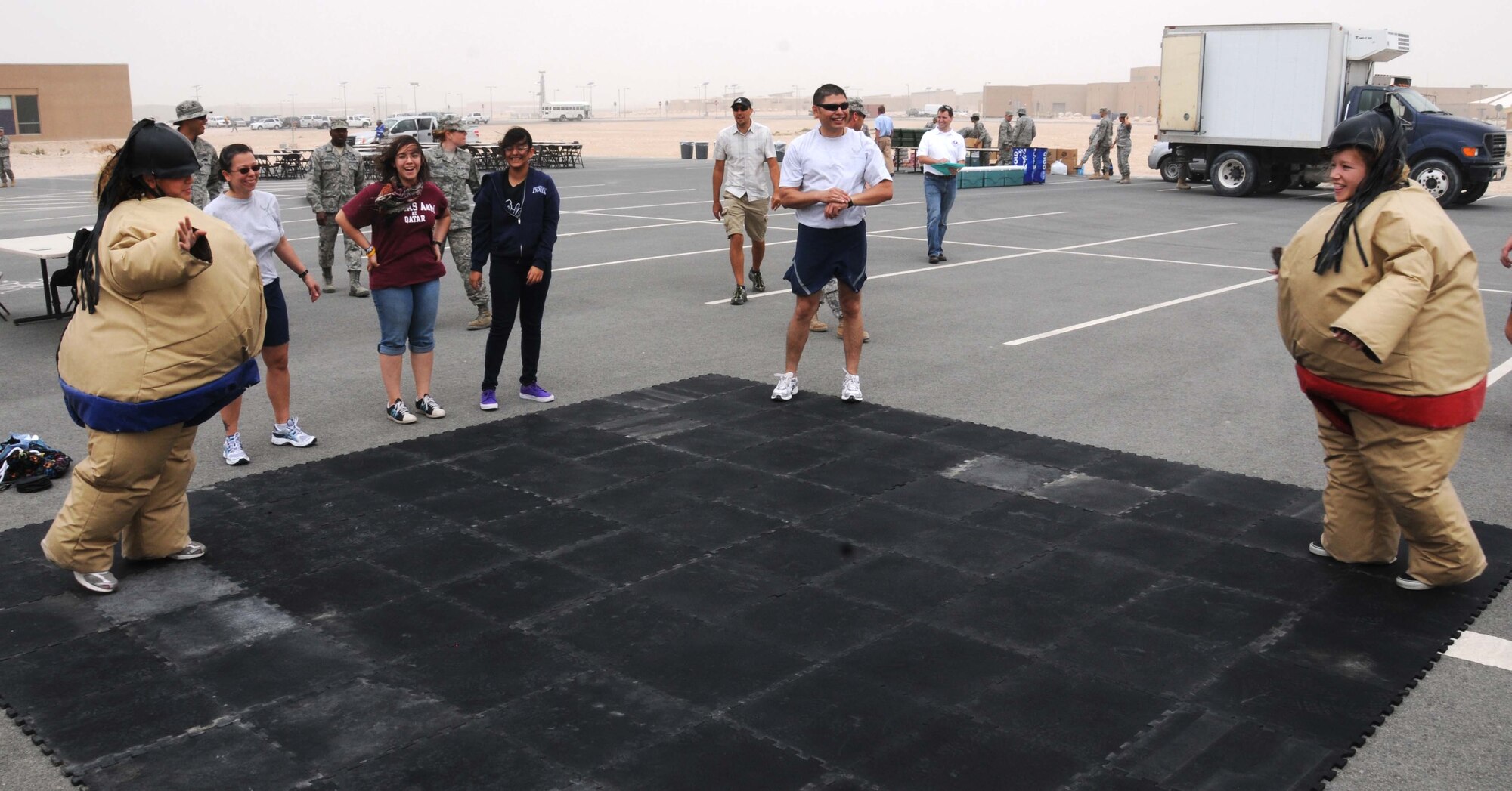 Students from the American School participate in a Sumo Wrestling match April 14 in Southwest Asia. Airmen from the 379th Air Expeditionary Wing spent the day with the students participating in different activities. (U.S. Air Force photo/ Staff Sgt. Anthony Graham)