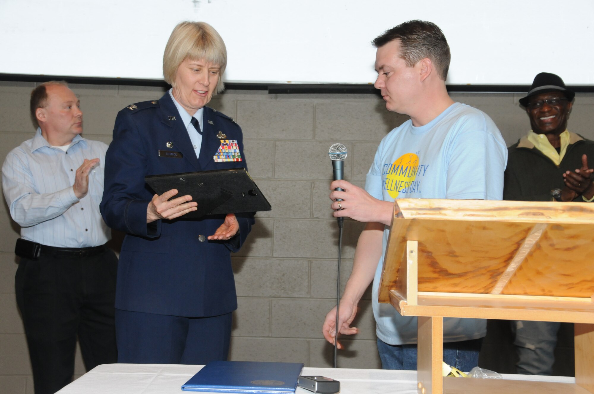 U.S. Air Force Col. Penny Dieryck, commander of the 148th Fighter Wing's Mission Support Group, is seen accepting the Community Champion Award on behalf of the 148 FW, Duluth, Minn., April 16, 2011. The Community Champion Award, presented by Dr. Anthony Macioce of Associated Chiropractic, was given to the 148 FW for continued unselfish commitment to serving the needs of the local community. (U.S. Air Force photo by Senior Airman Sarah C. Hayes)