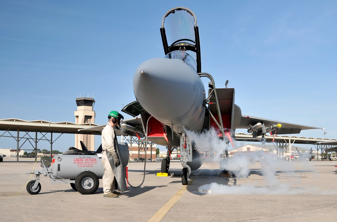 Technical Sergeant Sean Becker from the 104th
Fighter Wing, Massachusetts Air National Guard refills the oxygen system on
an F-15 Eagle before a sortie on April 11, 2011. Deployed to Tyndall Air
Force Base in Florida, the 104th is participating in the Weapons System
Evaluation Program (WSEP). The two week training and evaluation program is
important for ground crews to test their maintenance systems and processes
while loading live munitions on F-15 Eagles, as well as critical live
training for the F-15 pilots to employ air-to-air missiles against real
world targets. (U.S. Air Force Photo by: Master Sergeant, Mark W. Fortin)
