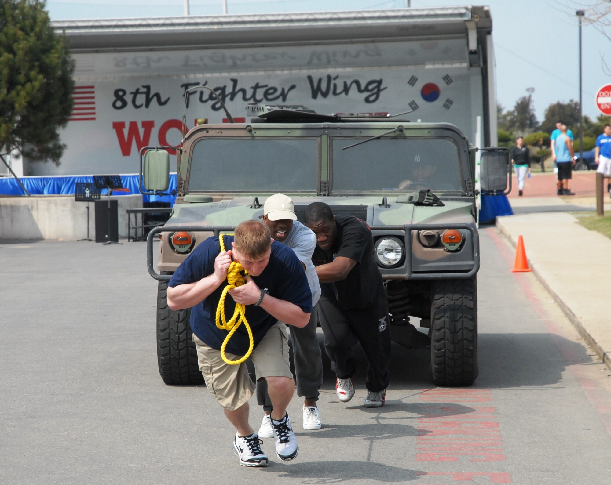 KUNSAN AIR BASE, Republic of Korea -- Members of the base fire department participate in a “humvee” pull at the 8th Fighter Wing’s post operational readiness inspection block party here April 15. After having received an overall rating of “Excellent” from the Pacific Air Force’s Inspector General, Col. John Dolan, 8th FW commander, authorized a celebration for a job well done. The block party included several events such as bowling and 3-on-3 basketball tournaments, live bands, softball, a dunk tank and more. (U.S. Air Force photo/Yi Song-Chin)