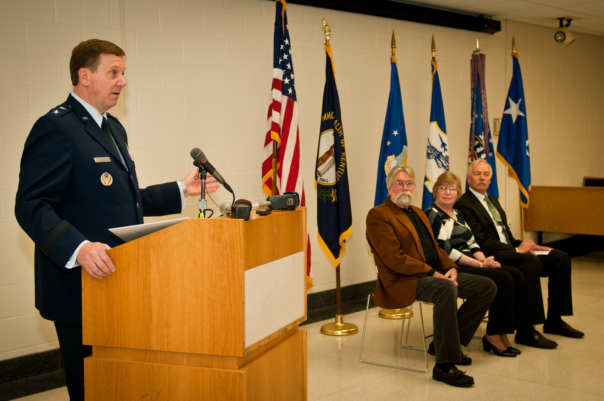 Maj. Gen. Edward W. Tonini, the Kentucky adjutant general, speaks about the sacrifice of the late Capt. Merlin R. "Bob" Kehrer, a former Kentucky Air Guard pilot, during a ceremony April 16, 2011, at the Kentucky Air National Guard Base in Louisville, Ky., to present the sons and daughter of the Airman a posthumous Prisoner of War Medal. Captain Kehrer was a young lieutenant and P-51 pilot in the U.S. Army Air Corps when his plane was shot down over enemy territory Feb. 24, 1944, and he was held in a German prisoner of war camp for 13 months. The family members (from left) are Tom Kehrer, Bonnie Urbanski and Bob Kehrer. (U.S. Air Force photo/Tech. Sgt. Dennis Flora)