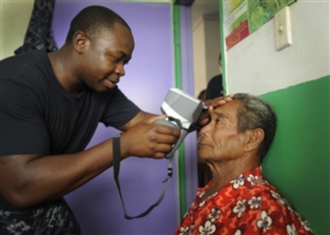 U.S. Navy Petty Officer 2nd Class Fitzroy Hall uses an autorefractor machine during an eye examination at a medical civic assistance program at the Prince Ngu Hospital in Neiafu, Vava'u, Tonga, on April 14, 2011.  Pacific Partnership is an exercise designed to strengthen alliances, improve U.S. and partner capacity to deliver humanitarian assistance and disaster relief and improve security cooperation among partner nations.  