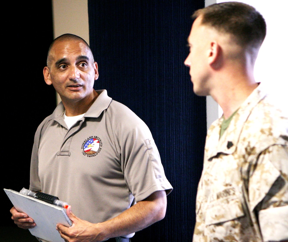 The class presented a token of appreciation to Robert Flores at the close of the graduation of the first graduating class of the newly formed Marine Corps Security Augment Force, April 18, at Marine Forces Reserve Headquarters, here.
