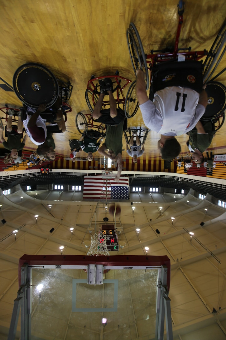 A wounded warrior with the Warrior Athlete Reconditioning Program, Wounded Warrior Battalion – East, goes for the net during their first wheelchair basketball game at the Geottge Memorial Field House aboard Marine Corps Base Camp Lejeune, April 19. The wounded warriors faced off against staff members of the WWBn-East and won with a score of 34-14.