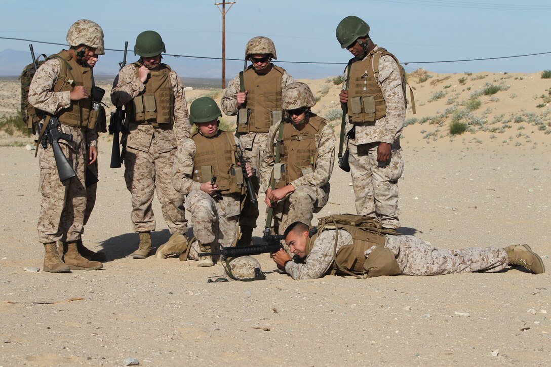 Headquarters Battalion Marines take some quick pointers from 1st Sgt. Nelson Hidalgo, the first sergeant for Company B, HQBN, before beginning a shooting competition April 19, 2011, at the Combat Center’s Range 103.::r::::n::