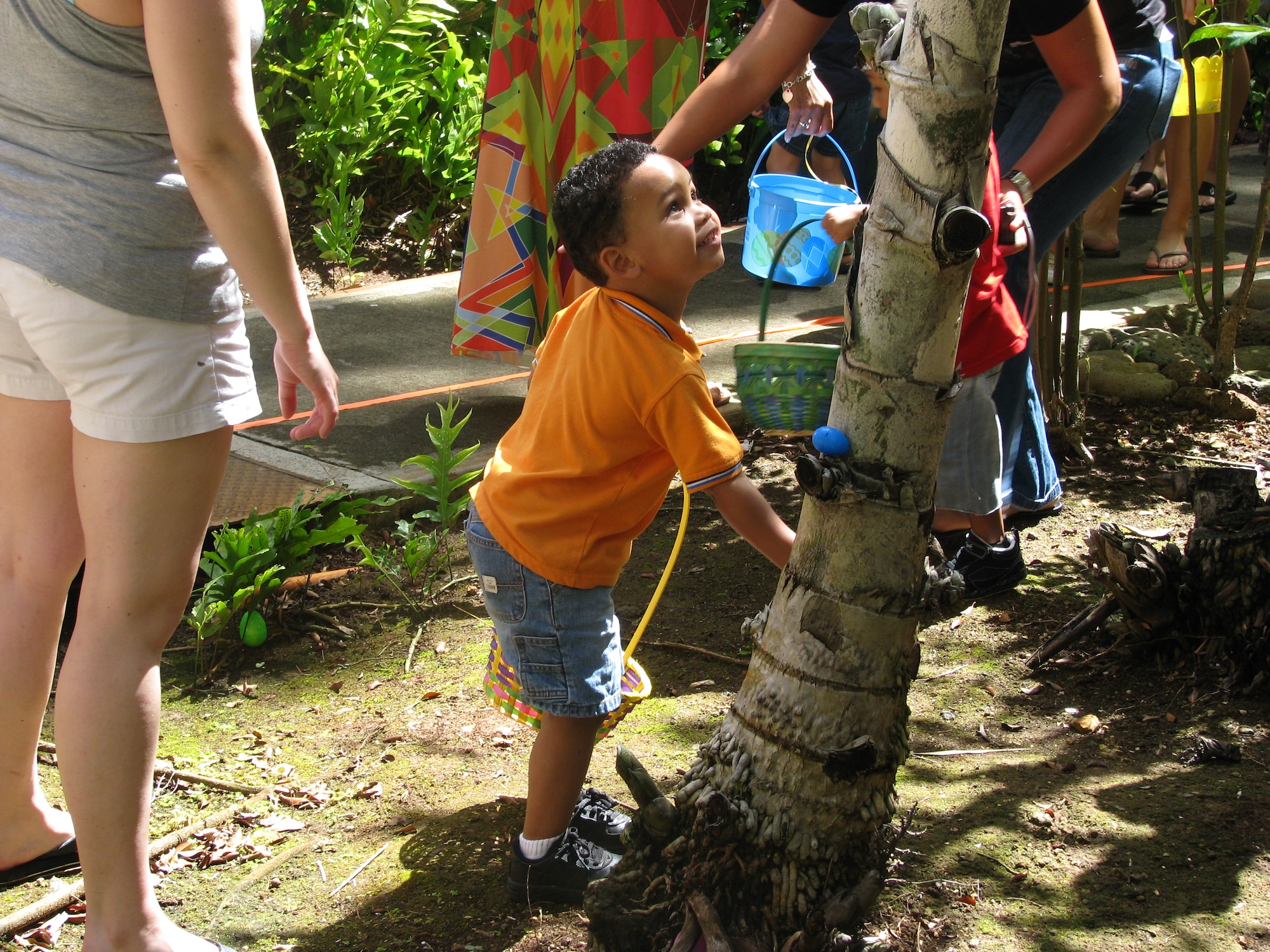 Children of deployed/remote Airmen and Individual Augmentee (IA) Sailors enjoy an Easter egg hunt sponsored by the 15th Medical Group on April 16 held on the tower lawn of the Hickam side of Joint Base Pearl Harbor-Hickam. The event included free food, bouncy castles, games, a duck pond and face painting. Photo by Drew Kadokawa.