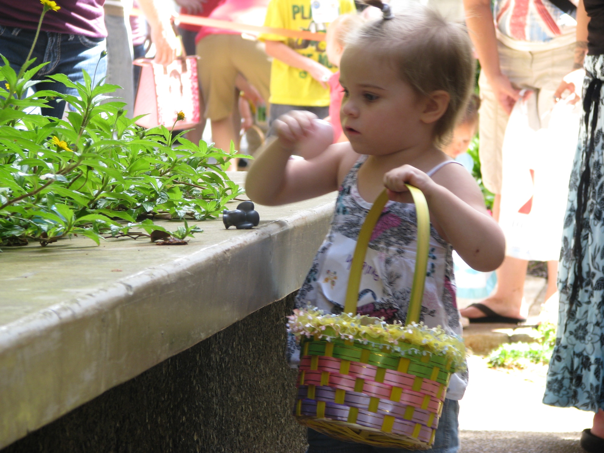 Children of deployed/remote Airmen and Individual Augmentee (IA) Sailors enjoy an Easter egg hunt sponsored by the 15th Medical Group on April 16 held on the tower lawn of the Hickam side of Joint Base Pearl Harbor-Hickam. The event included free food, bouncy castles, games, a duck pond and face painting. Photo by Drew Kadokawa.