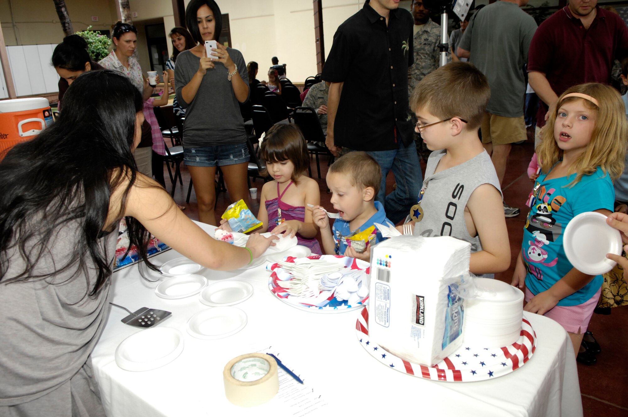 Alexis Warnet, Noah Warnet, Hunter Pruitt, and Chloe Pruitt enjoy cake after receiving medals as Homefront Heroes, recognizing them for their contributions and sacrifices during their sponsor's military deployment.  Photo by David D. Underwood, Jr.