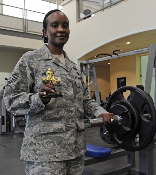 Tech. Sgt. Linda Webber, 2nd Force Support Squadron, holds a trophy in the fitness center on Barksdale Air Force Base, La., April 19. Sergeant Webber was the top female performer in the Maxed Out Friday Bench Press Competition. Contestants were given three attempts to reach their maximum lifting weight. (U.S. Air Force photo/Airman 1st Class Micaiah Anthony)(RELEASED)