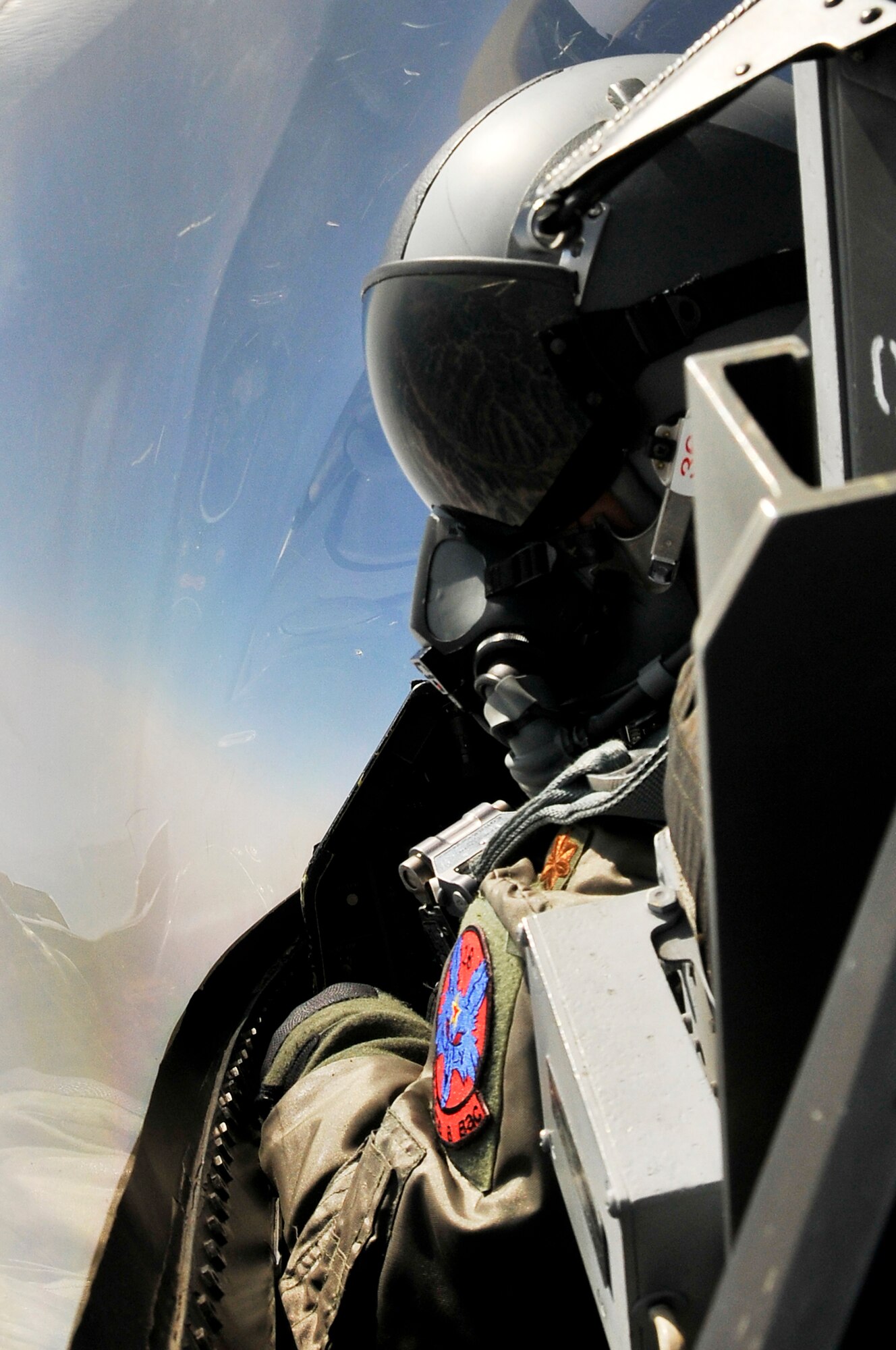 Maj. John Wolinski looks for adversaries during RED FLAG-Alaska sortie in an F-16 Fighting Falcon April 18, 2011, Eielson Air Force Base, Alaska. RED FLAG-Alaska enables aviation units to sharpen combat skills by flying ten simulated combat sorties in a realistic threat environment. Additionally, the training allows units to exchange tactics and techniques to improve interoperability. Major Wolinski is an F-16 pilot assigned to the 18th Aggressor Squadron. (U.S. Air Force photo/Staff Sgt. Christopher Boitz)