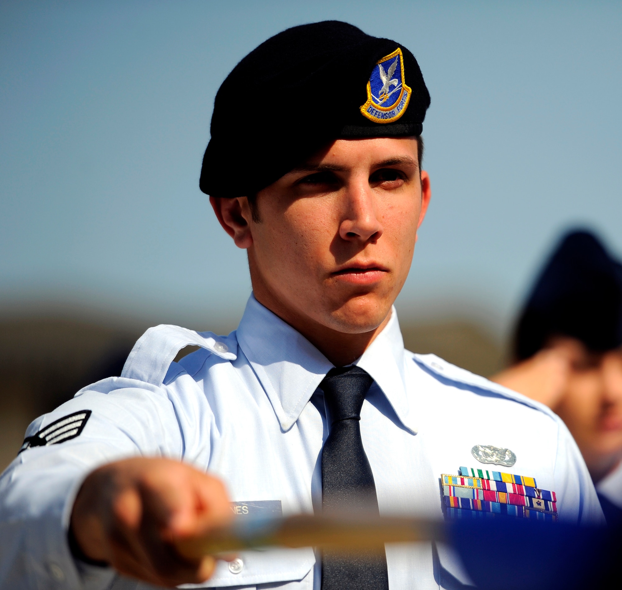 Senior Airman Stuart Jones, 1st Special Operations Security Forces Squadron, salutes with the guidon during an Airman Leadership School memorial ceremony for Airman 1st Class John Vincent, April 18, 2011 at Hurlburt Field, Florida. Airman Vincent was killed by lightning 15 years ago while working on the flight line here. Hurlburt Field's ALS is named after Airman Vincent.  (U.S. Air Force photo by Senior Airman David Salanitri/Released) 
