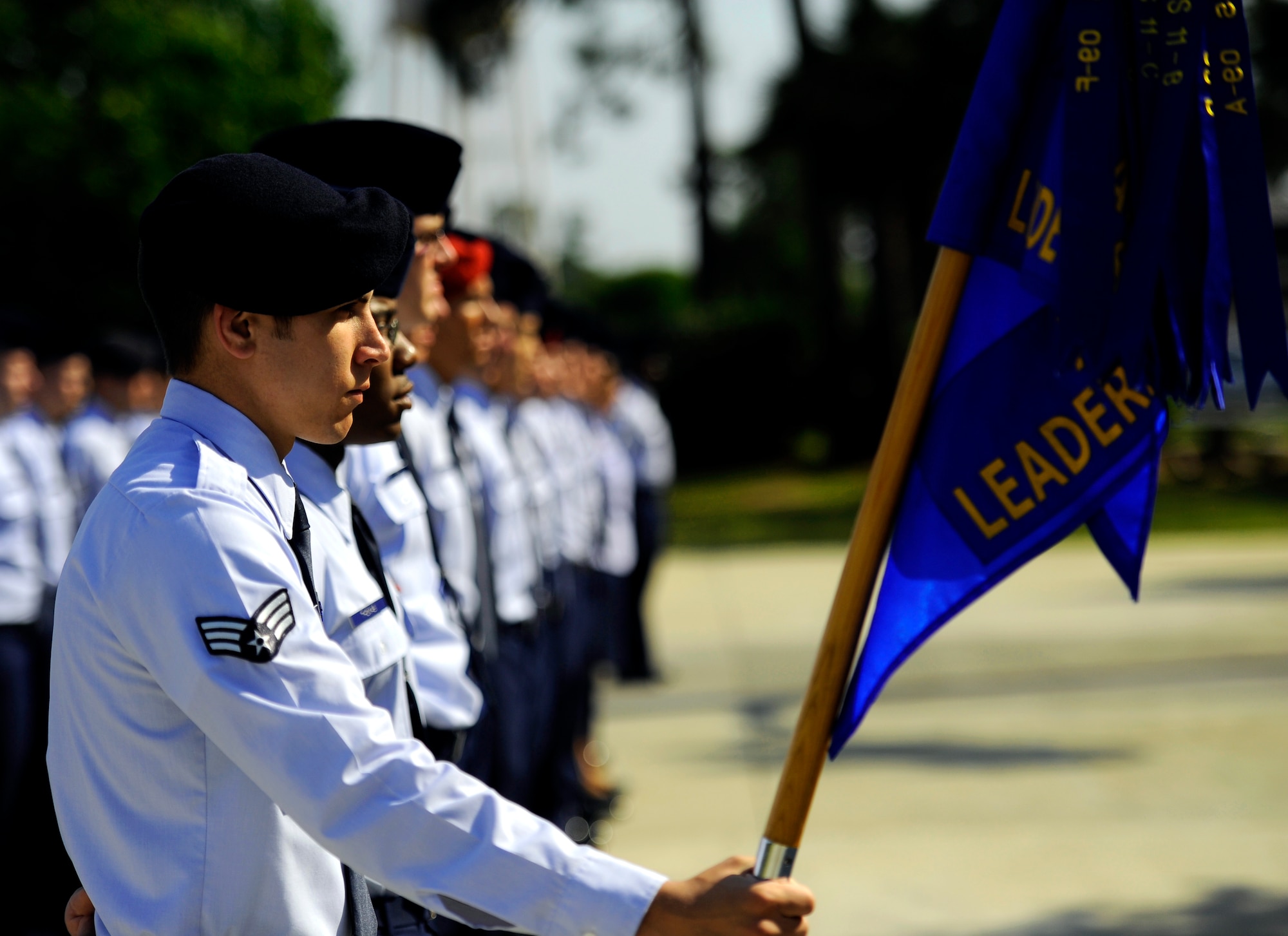 Senior Airman Stuart Jones, 1st Special Operations Security Forces Squadron, holds the guidon at parade rest during an Airman Leadership School memorial ceremony for Airman 1st Class John Vincent, April 18, 2011 at Hurlburt Field, Florida. Airman Vincent was killed by lightning 15 years ago while working on the flight line here. Hurlburt Field's ALS is named after Airman Vincent.  (U.S. Air Force photo by Senior Airman David Salanitri/Released) 