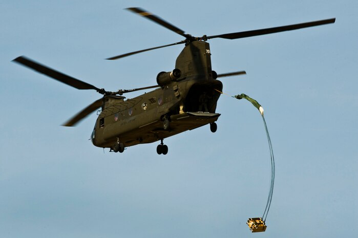 NELLIS AIR FORCE BASE, Nev. -- A Nevada Army National Guard CH-47 Chinook helicopter, 1/189th Aviation Company, drops a package April 15. Airborne RED HORSE are  different than the rest of traditional RED HORSE squadrons in that members are airborne qualified and use much lighter specialized equipment.(U.S. Air Force photo by Senior Airman Brett Clashman)
