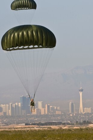 NELLIS AIR FORCE BASE, Nev. -- Airman from 820th RED HORSE Squadron Airborne Flight, prepare for landing after a static line jump from a Nevada Army National Guard 1/189 Aviation Company CH-47 Chinook helicopter, April 15. Airborne RED HORSE are  different than the rest of traditional RED HORSE squadrons in that members are airborne qualified and use much lighter specialized equipment.(U.S. Air Force photo by Senior Airman Brett Clashman)