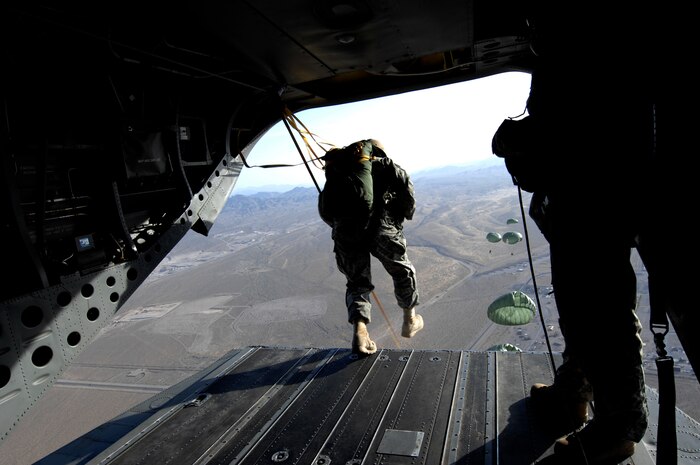 NELLIS AIR FORCE BASE, Nev. -- Air Force jumpers from the 820th RED HORSE squadron, airborne flight, execute a static line jump from a CH-47 Chinook helicopter April 15. Airborne RED HORSE are significantly different than the rest of traditional RED HORSE in that members are airborne qualified and use much lighter specialized equipment. (U.S. Air Force photo by Master Sgt. Kevin J. Gruenwald)