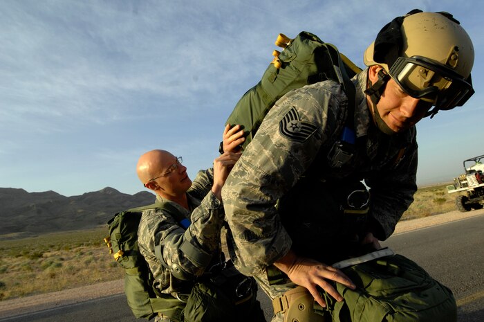 NELLIS AIR FORCE BASE, Nev. --(left) Tech. Sgt. Matthew Phillips performs a Jumpmaster Pre-Inspection on Tech. Sgt. Jordan Bunting prior to a static line jump April 15. Both are U.S. Air Force jumpers from the 820th Airborne RED HORSE squadron Nellis AFB. Airborne RED HORSE are significantly different than the rest of traditional RED HORSE in that members are airborne qualified and use much lighter specialized equipment. (U.S. Air Force photo by Master Sgt. Kevin J. Gruenwald)