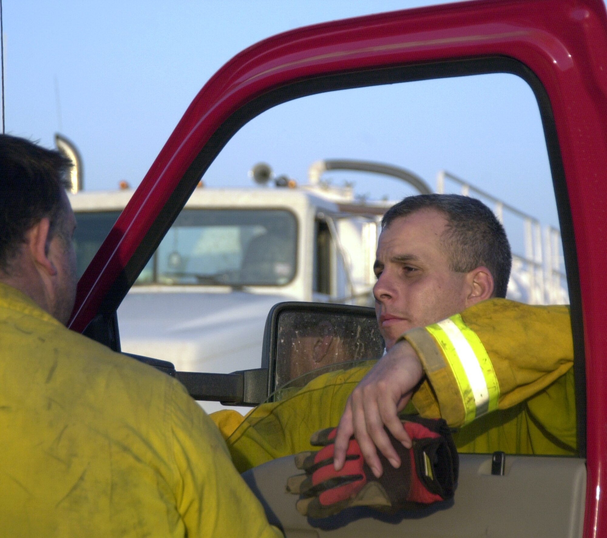 COKE COUNTY, Texas -- Tech. Sgt. John Deese, Louis F. Garland Fire Academy instructor, takes a moment to speak with a volunteer firefighter after a 12-hour night shift battling part of the Wildcat blaze off U.S. Highway 77 April 19.  Sergeant Deese is one of eight academy instructors that have teamed up with Goodfellow and surrounding firefighters to keep the fire from taking lives and homes. (U.S. Air Force photos/Connie Hempel)