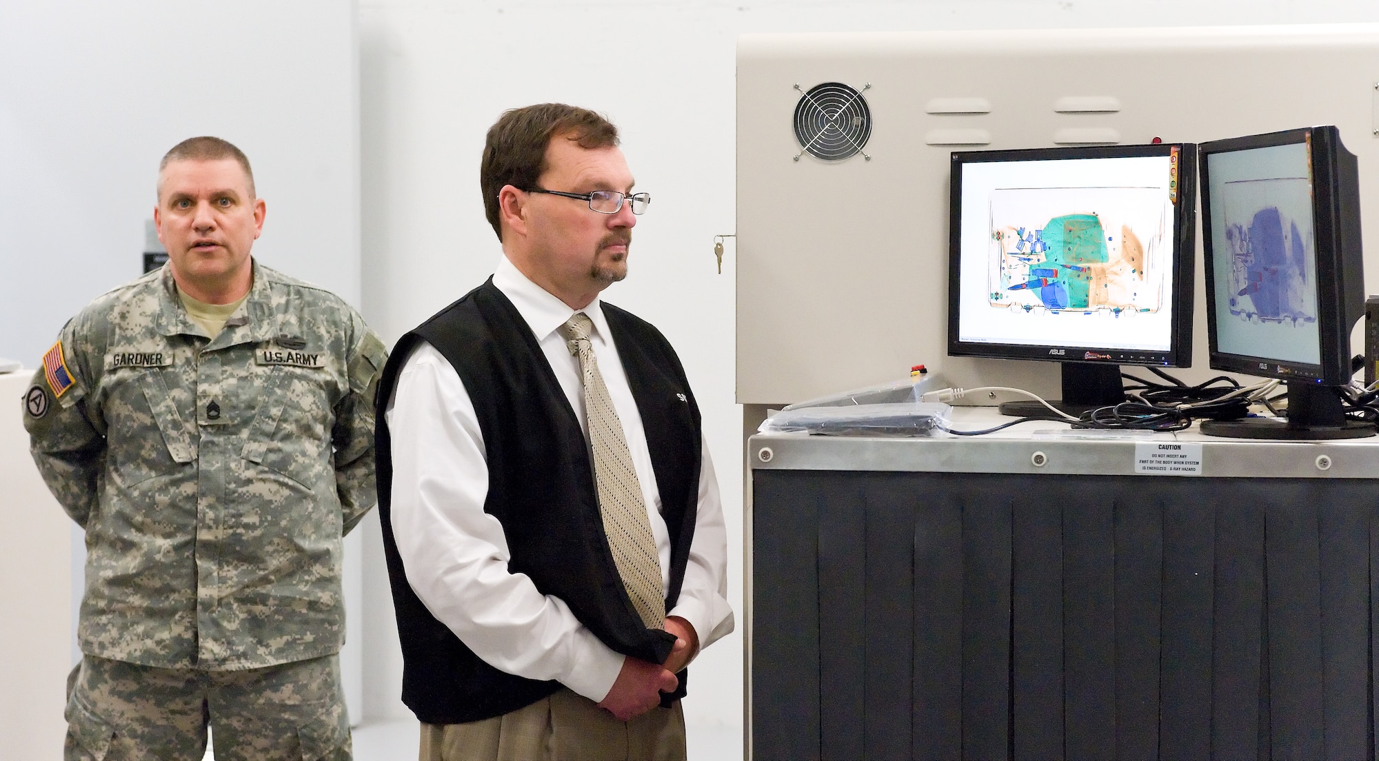 Troy Harden demonstrates how a personal effects container is scanned to display the contents within April 14, 2011, at the Joint Personal Effects Depot facility at Dover Air Force Base, Del. (U.S. Air Force photo by Roland Balik)