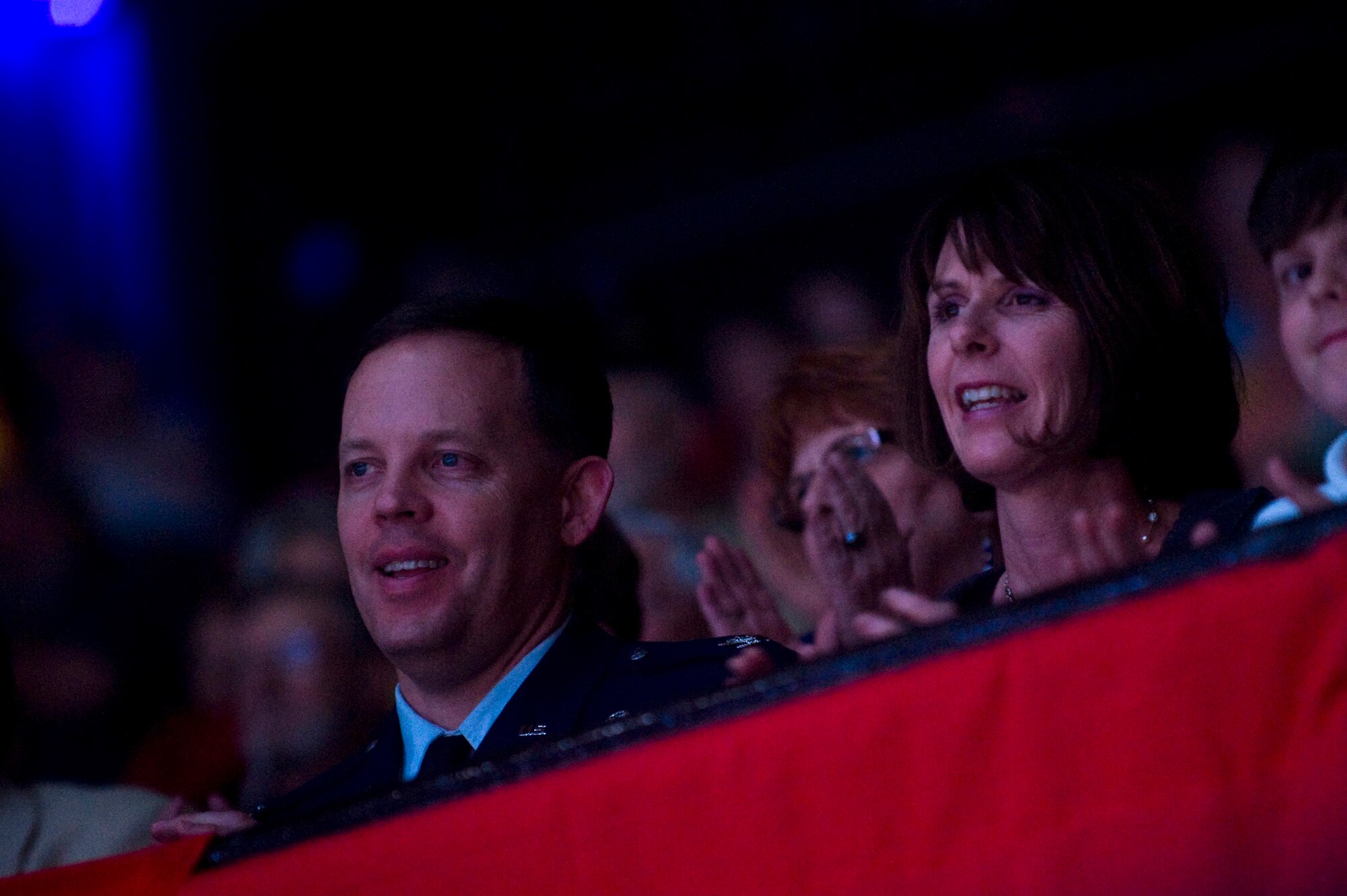 LAS VEGAS -- Col. Steven Garland, 99th Air Base Wing commander, Nellis Air Force Base, Nev., enjoys the show with his family during the International Tattoo at the Thomas & Mack Center April 15. The international tattoo is a show celebrating the contribution of America's armed forces. (U.S. Air Force photo by Senior Airman Brett Clashman)