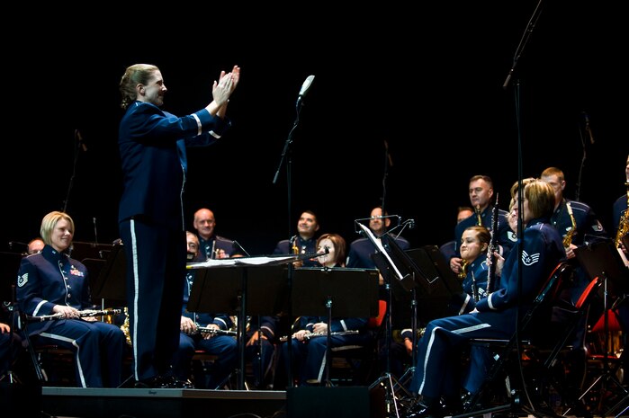 LAS VEGAS --  U.S. Air Force Band of the Golden West applaud themselves after a performance during the International Tattoo at the Thomas & Mack Center April 15. The international tattoo is a show celebrating the contribution of America's armed forces. (U.S. Air Force photo by Senior Airman Brett Clashman)