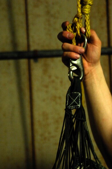 Senior Airman Austin Lee, 38th Rescue Squadron aircrew flight equipment journeyman, waits for another parachute to add to the hook before hoisting them to dry April 8 at Moody Air Force Base, Ga. Drying the parachutes takes three to four days and is done after the parachutes are used for water training by the squadron’s pararescuemen.  (U.S. Air Force photo/Airman 1st Class Brigitte N. Brantley-Sisk)(RELEASED)
