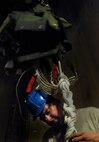 Staff Sgt. Clint Scott, 38th Rescue Squadron aircrew flight equipment NCO, undoes the daisy chain of an MC-5 parachute April 8 in a drying tower Moody Air Force Base, Ga. This parachute was one of about 50 used to support 38th RQS pararescuemen during recent water training. (U.S. Air Force photo/Airman 1st Class Brigitte N. Brantley-Sisk)(RELEASED)

