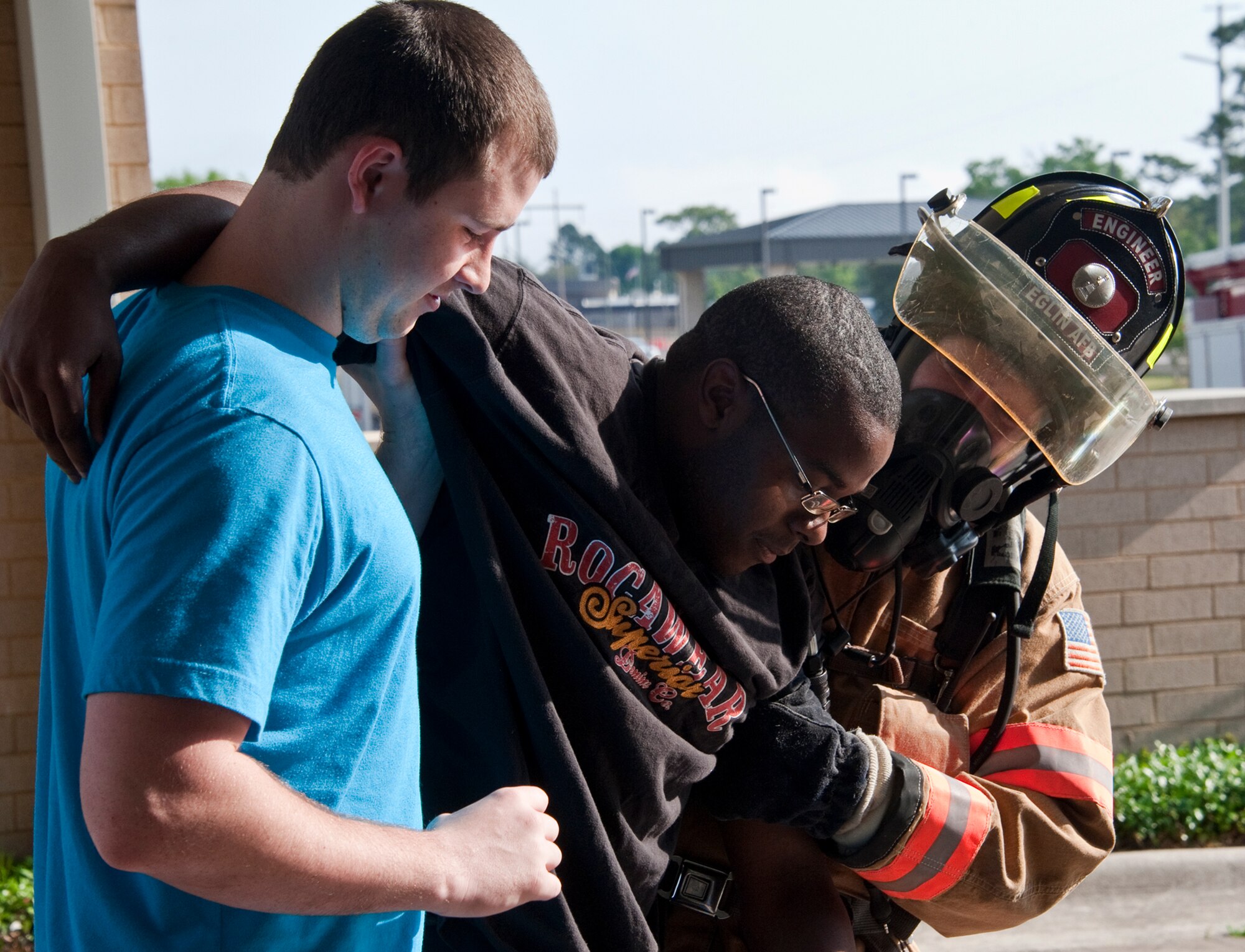 A victim is helped out of the building during a simulated chemical agent/suspicious package exercise April 19 at Eglin Air Force Base, Fla.  Firefighters, security forces and emergency personnel responded to the incident and the building was evacuated and cordoned during the exercise.    (U.S. Air Force photo/Samuel King Jr.)