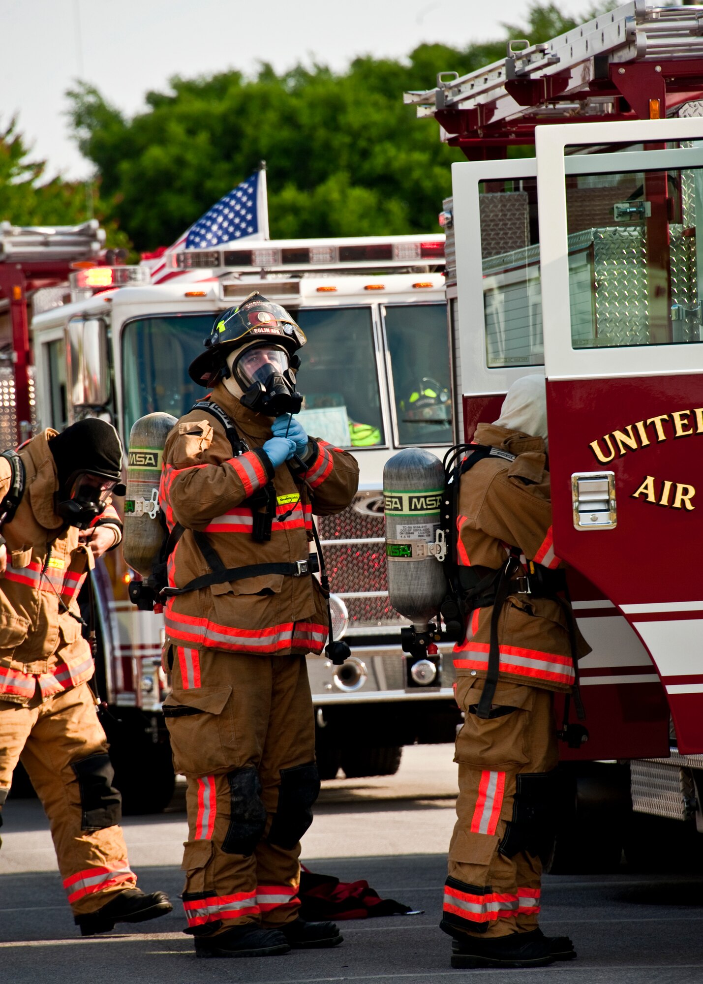 Firefighters gear up prior to entering the building during a simulated chemical agent/suspicious package exercise April 19 at Eglin Air Force Base, Fla.  Firefighters, security forces and emergency personnel responded to the incident and the building was evacuated and cordoned during the exercise.    (U.S. Air Force photo/Samuel King Jr.)