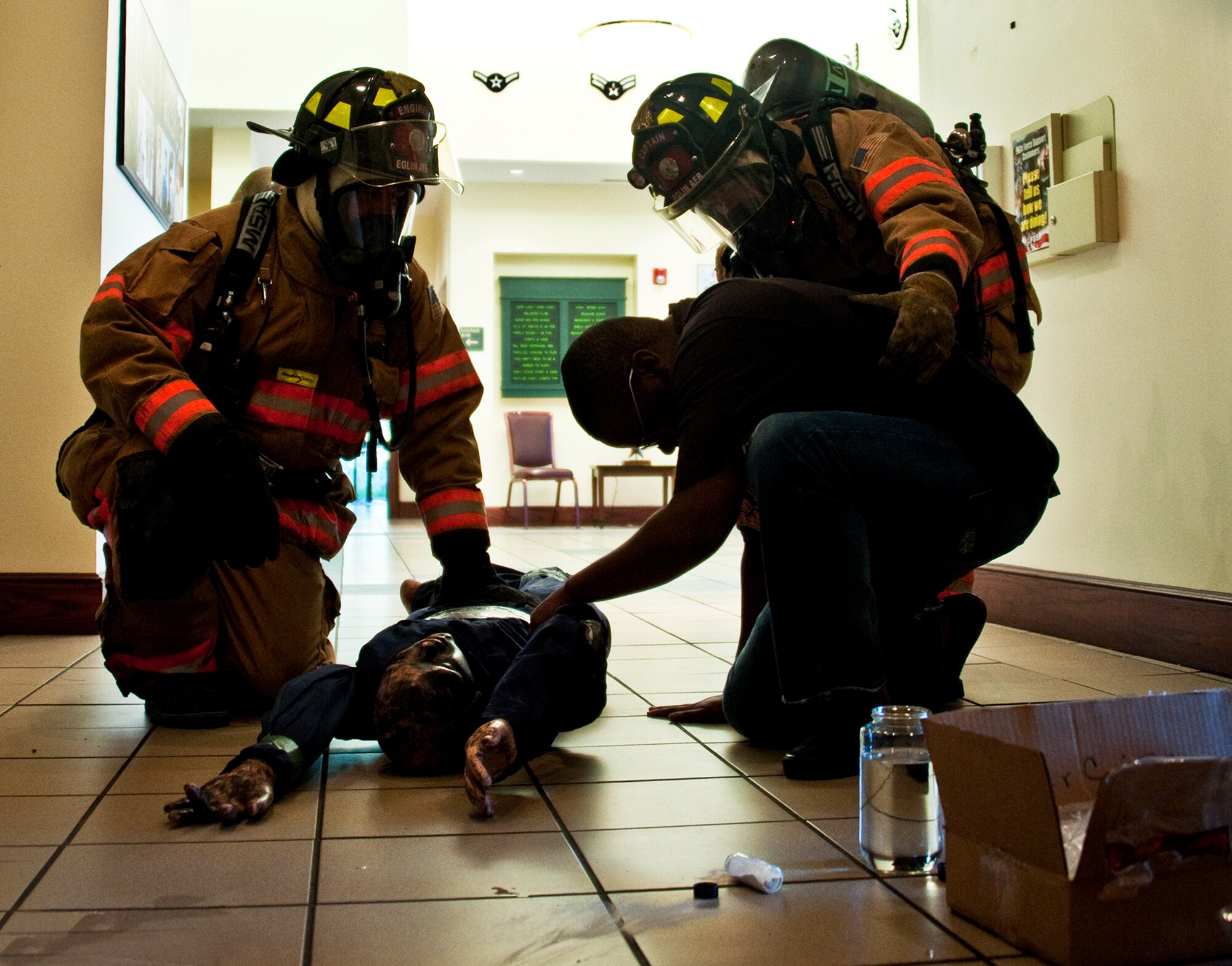 Firefighters discover victims during a simulated chemical agent/suspicious package exercise April 19 at Eglin Air Force Base, Fla.  Firefighters, security forces and emergency personnel responded to the incident and the building was evacuated and cordoned during the exercise.    (U.S. Air Force photo/Samuel King Jr.)