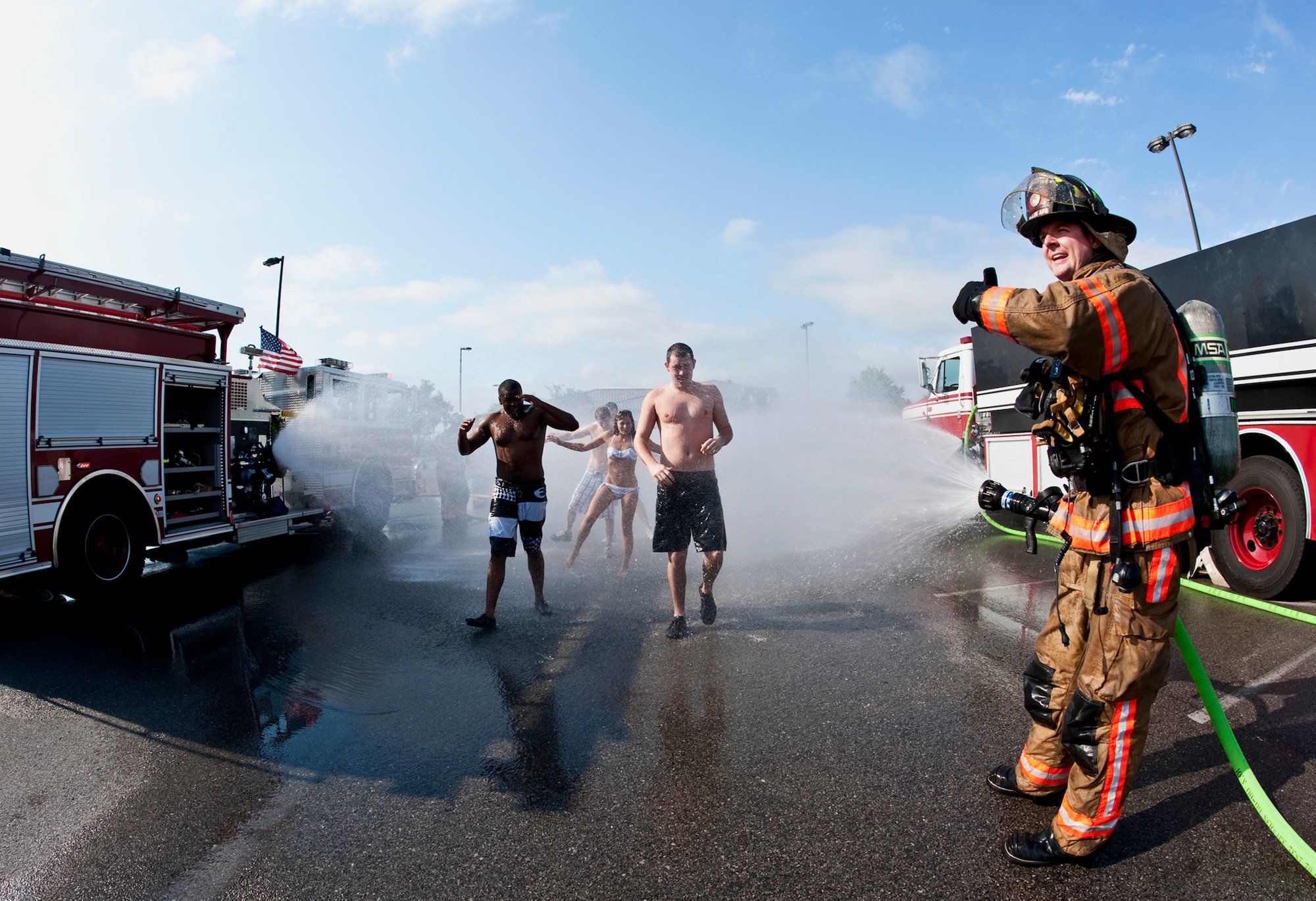 Justin Curtis, 96th Civil Engineer Squadron, calls for emergency personnel as victims exit the decontamination area during a simulated chemical agent/suspicious package exercise April 19 at Eglin Air Force Base, Fla.  Firefighters, security forces and emergency personnel responded to the incident and the building was evacuated and cordoned during the exercise.    (U.S. Air Force photo/Samuel King Jr.) 