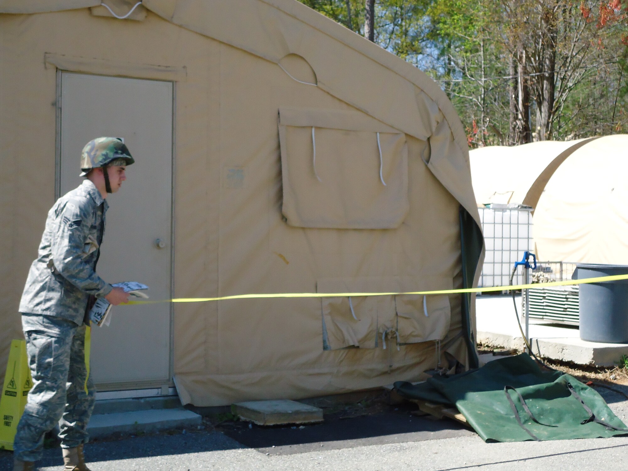 Senior Airman Vitaliy Gorbachyk, 103rd Force Support Squadron, Conn. Air National Guard, cordons off a UXO during a combat training exercise March 24 at Dobbins Air Reserve Base, Ga.  A team of 15 Connecticut Guardsmen deployed with members of the 104th FSS and MacDill AFB where they focused on wartime/contingency operations relative to a force beddown. (Photo courtesy of Master Sgt. Melissa A. Letizio)