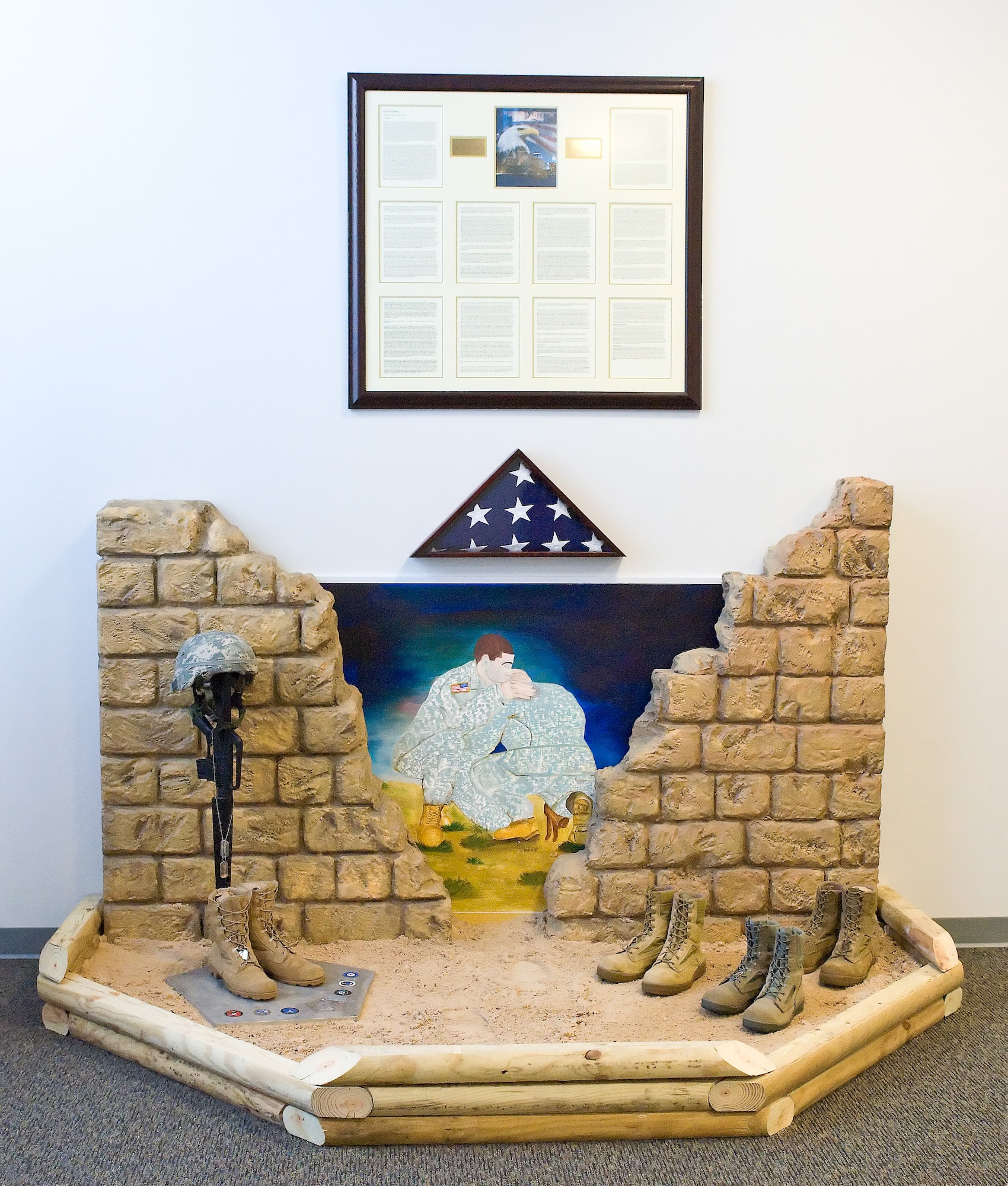 A mural, designed and constructed by members of the Joint Personal Effects Depot, is displayed April 14, 2011, in the JPED facility at Dover Air Force Base, Del., in dedication of fallen servicemembers and their families. (U.S. Air Force photo by Roland Balik)