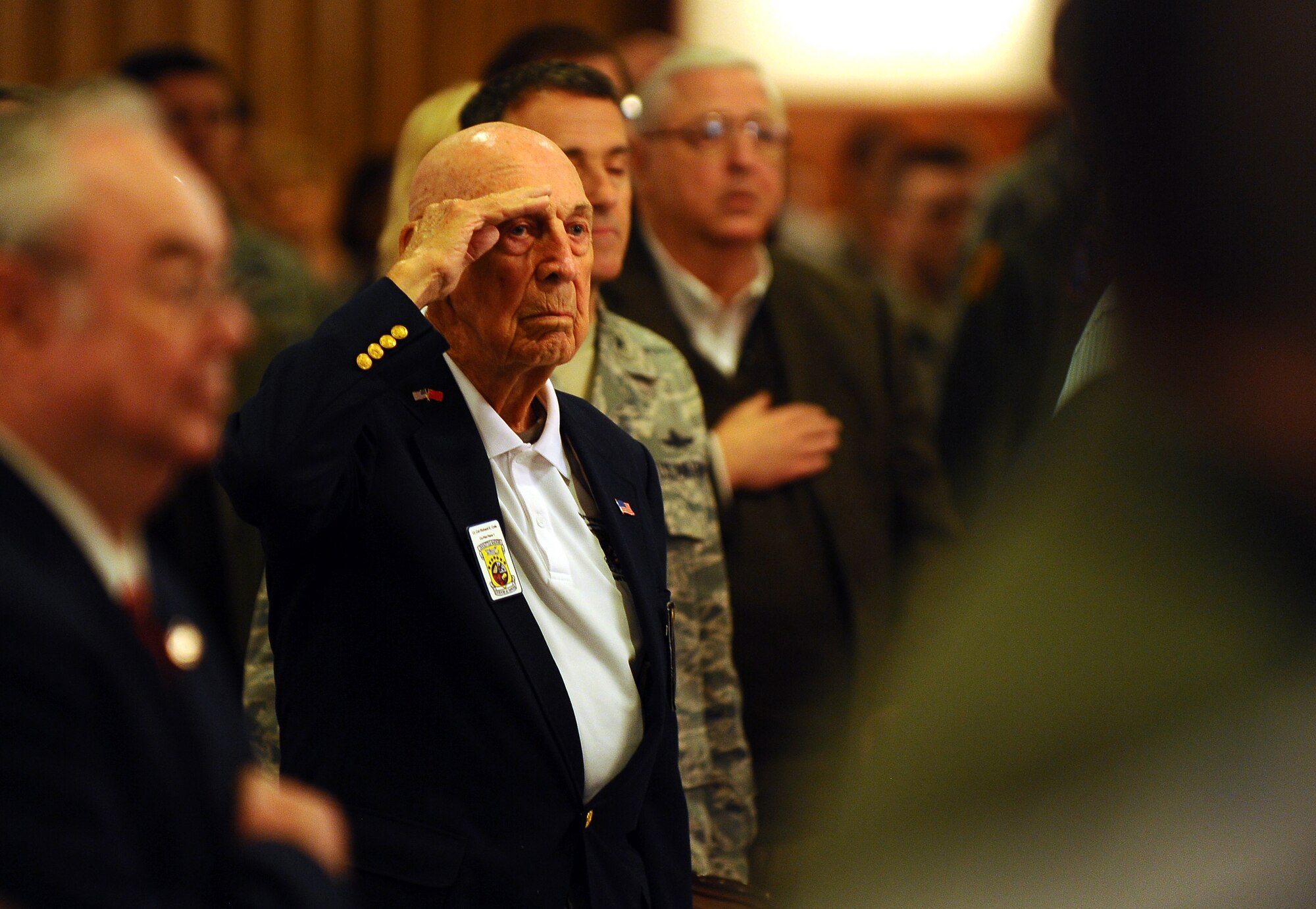 OFFUTT AIR FORCE BASE, Neb. -- Doolittle Raider Richard Cole, who was a co-pilot on crew 1 for Lt. Col. James H. "Jimmy" Doolittle, salutes during the playing of the national anthem at a luncheon held here April 15. The event was part of the raider's 69th annual reunion, which took place this year in Nebraska from April 14-17. (Air Force photo by Josh Plueger)