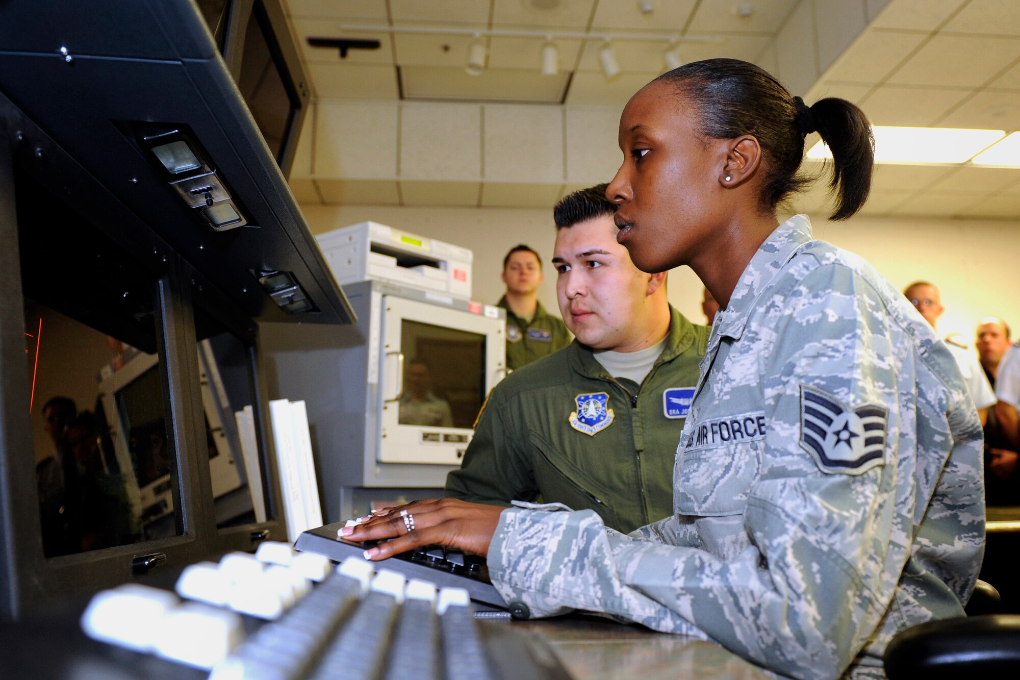 SCHRIEVER AIR FORCE BASE, Colo. -- Staff Sgt. Lakisha Massengale and Senior Airman Jon Mondragon, 4th Space Operations Squadron, run final system checks and shutdown procedures for the Satellite Mission Control Segment Apri 18. (Air Force Photo/Dennis Rogers)