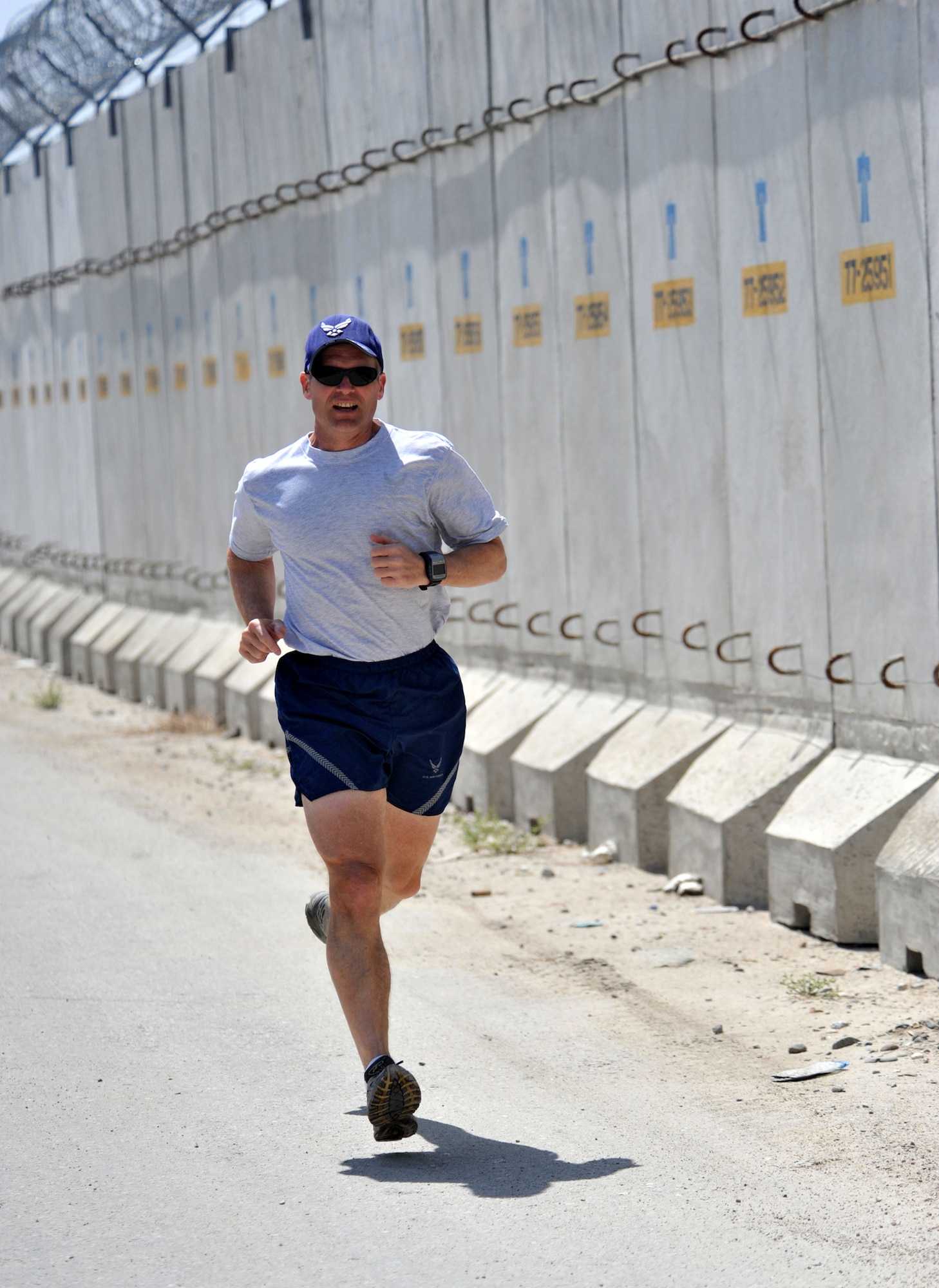 Col. (Dr.) Christian Benjamin takes off on his daily run April 12, 2011, at Bagram Airfield, Afghanistan. Dr. Benjamin is the commander of the 455th Expeditionary Medical Group. Over the course of 12 years, he has run more than halfway around the world, including more than 2,750 miles during deployment to Iraq and Afghanistan. (U.S. Air Force photo/Senior Airman Sheila deVera)