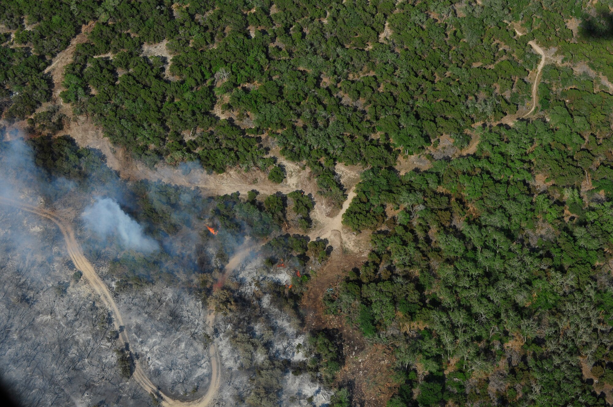 LAUGHLIN AIR FORCE BASE, Texas:  A wildfire burns land near Austin, Texas, April 17, 2011. U.S. Northern Command has deployed six C-130 aircraft fitted with the U.S.D.A. Forest Service’s Modular Airborne Fire Fighting Systems to support the fight against ongoing wildfires. (U.S. Air Force photo by Staff Sgt. Quinton Russ)