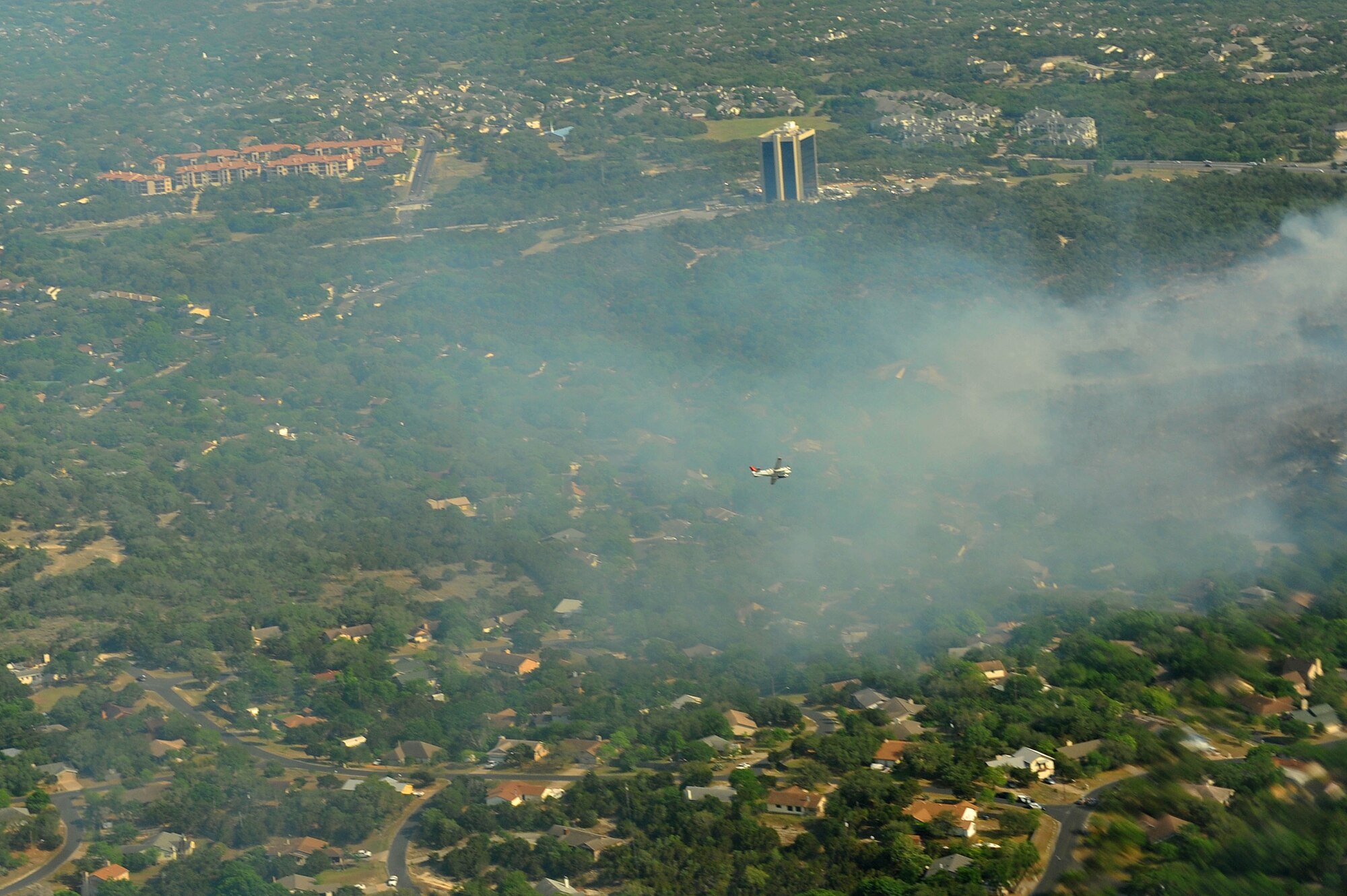 LAUGHLIN AIR FORCE BASE, Texas: A lead plane from the U.S.D.A. Forest Service guides a C-130 from the 302nd Airlift Wing, Peterson Air Force Base, Colo., toward a wildfire west of Austin, Texas, April 17. U.S. Northern Command has deployed six C-130 aircraft equipped with the U.S.D.A. Forest Service’s Modular Airborne Fire Fighting System to support the fight against ongoing wildfires in the area. (U.S. Air Force photo by Staff Sgt. Quinton Russ)