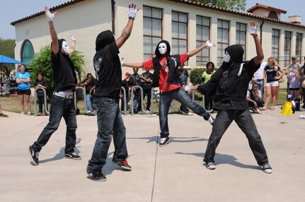 Step team dancers perform during Famaganza April 16 at Randolph Air Force Base, Texas. The family oriented event featured various dance troupes, an Easter egg hunt, rides for children, face painting, a book fair and free refreshments. (U.S. Air Force photo/David Terry)