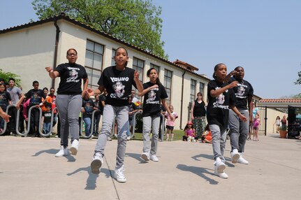 The "Young Stunnaz" varsity step team performs at Famaganza April 16  at Randolph Air Force Base, Texas.  The event also featured an Easter egg hunt, rides for children, a book fair, face painting, games and free refreshments. (U.S. Air Force photo/David Terry)
