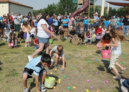 Children run for eggs at the Easter egg hunt  April 16, during Famaganza. The annual event hosted by the Youth Center at Randolph Air Force Base, Texas featured rides, games, prizes, a book fair, performances by dance troupes, and free refreshments.(U.S. Air Force photo/David Terry)