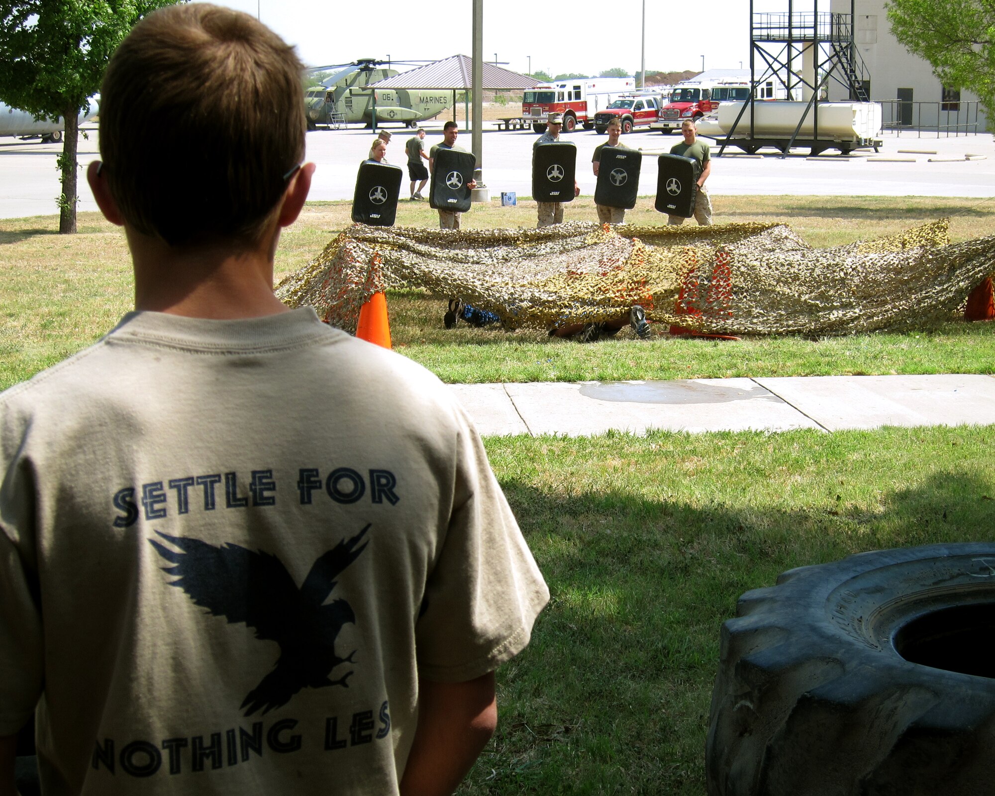 GOODFELLOW AIR FORCE BASE, Texas - A Scout with the Concho Valley Boy Scouts Troop 22 watches as other Scouts navigate an obstacle course at the Louis F. Garland Fire Academy here April 16. Goodfellow hosted this year's District Camporee, with more than 100 Scouts in attendance. (U.S. Air Force photo/Tech. Sgt. Jon DuMond)                  