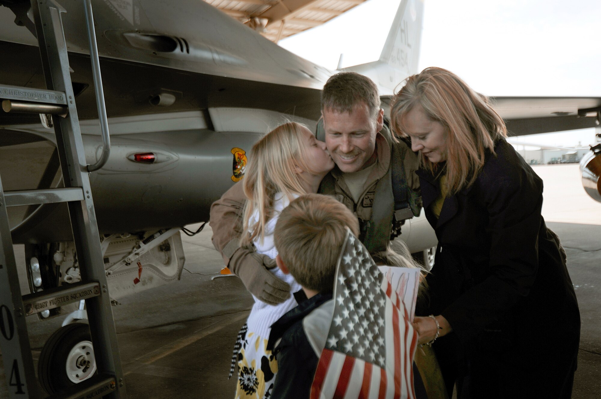 Col. William Bailey greets his wife and children upon his arrival April 15, 2011, at Hill Air Force Base, Utah. Colonel Bailey is the commander of the 4th Fighter Squadron and an F-16 Fighting Falcon pilot. He led six jets as the first of their team to return from a six-month deployment to Bagram Air Base, Afghanistan. (U.S. Air Force photo/Staff Sgt. Renae Saylock)