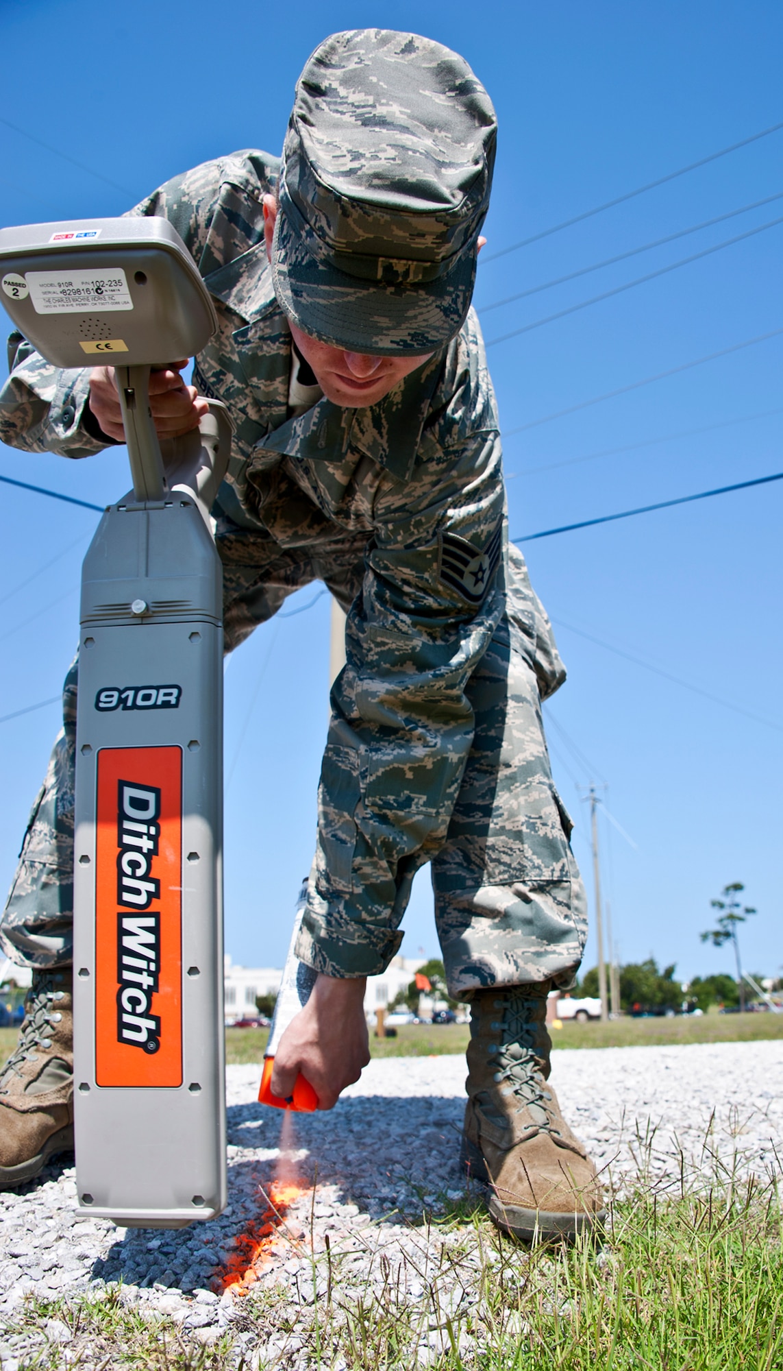 Staff Sgt. Jonathan Webber, 96th Communications Squadron, marks the ground with paint to identify where a copper communication cable is buried.  A machine set up by CS, continuously sent out a frequency that the copper pipe picks up.  The hand-held detector picks up that frequency from the copper pipes and shows the Airmen where it is located.  The CS Airmen were marking the cable location to identify them prior to construction in the area.  (U.S. Air Force photo/Samuel King Jr.)