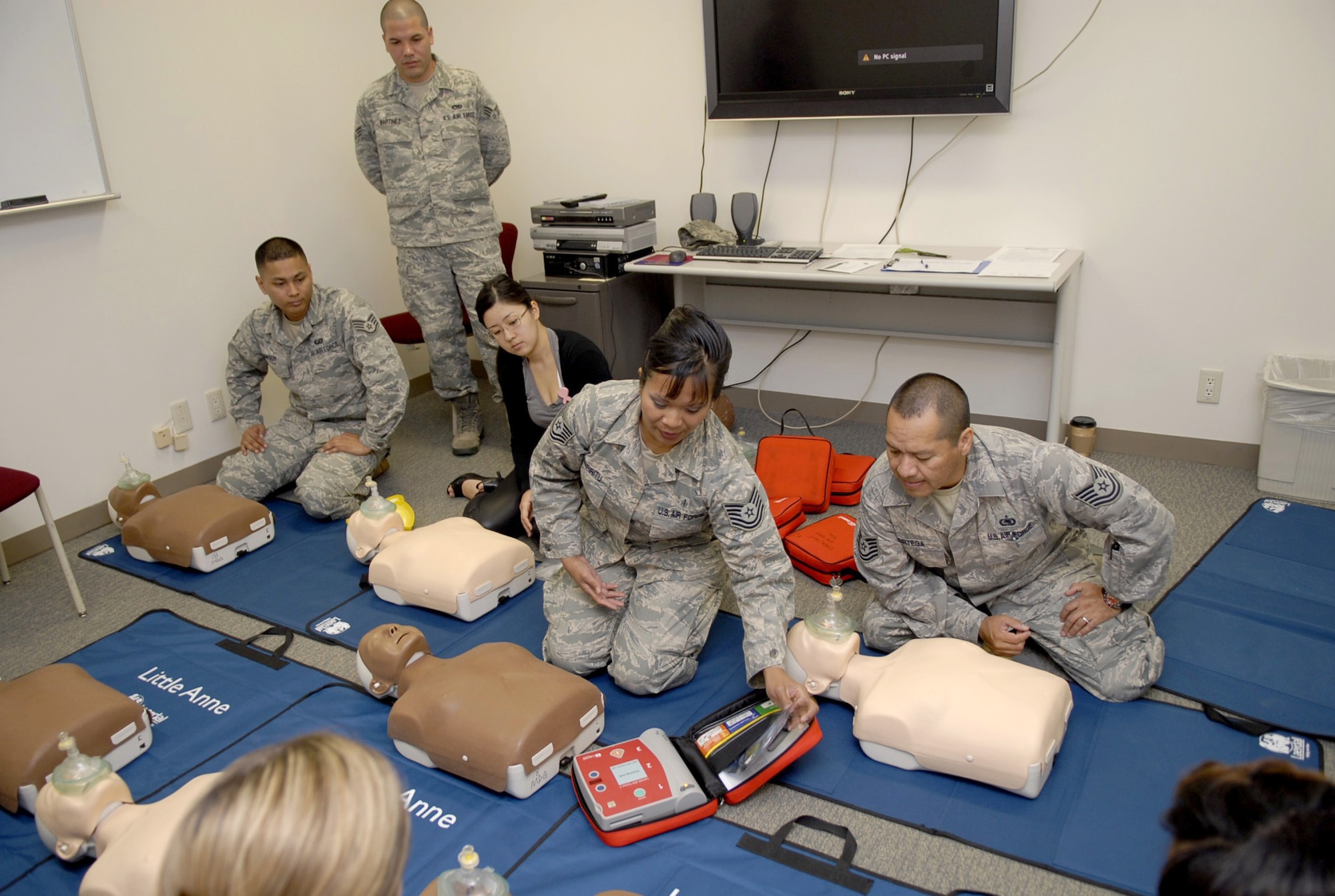Tech. Sgt. Jeanette Espiritu demonstrates how to apply automated external defibrillator pads April 15, 2011, during a Heartsaver class at Kadena Air Base, Japan. Sergeant Espiritu is a basic life-support administrator who taught the use of AEDs during the class where students learned the new American Heart Association CPR method of administering immediate chest compressions. (U.S. Air Force photo/Airman 1st Class Tara A. Williamson)