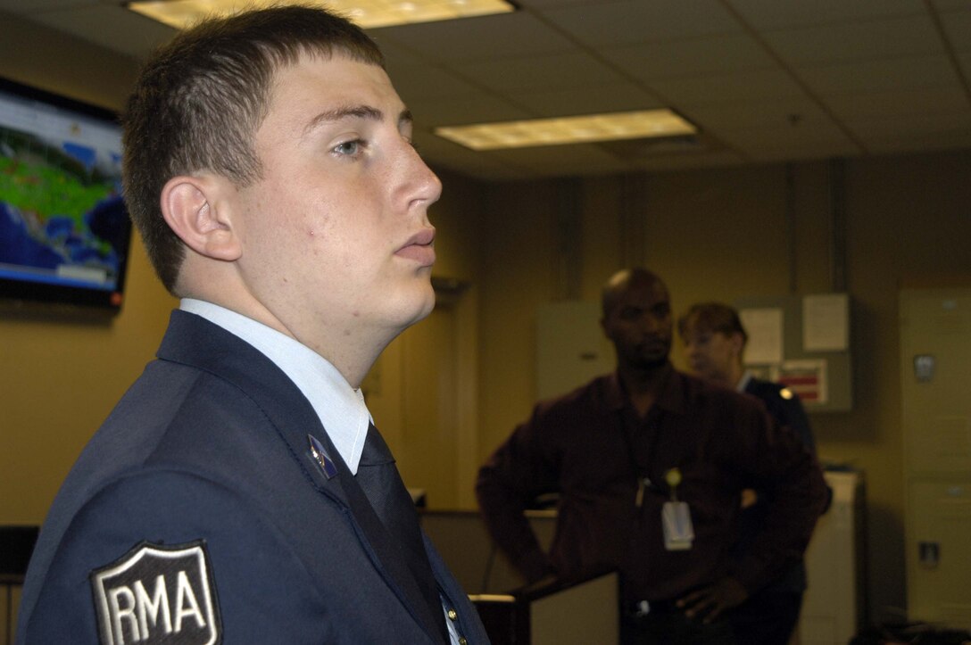 Cadet Tyler Atkinson listens to a briefing about how Air Forces Northern keeps its communications systems running properly. Cadet Atkinson, who will be attending a military college in the fall, spent a day at Tyndall Air Force Base, Fla., shadowing two Air Force communications officers. (U.S. Air Force photo by Angela Pope)