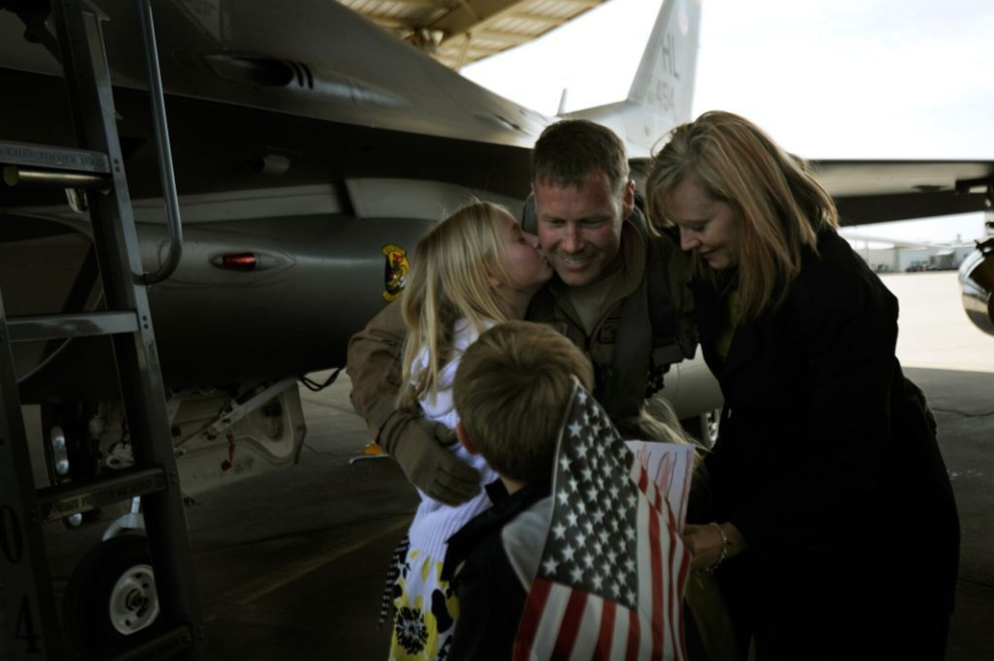 Lt.Col. William Bailey, 4th Fighter Squadron commander, greets his wife Monica and children Cori, Nate and Erin upon his arrival to Hill Air Force Base, Utah, Friday. Colonel Bailey and his team of six F-16s are the first to arrive home from a nearly seven month deployment at Bagram Airfield, Afghanistan. (U.S. Air Force photo/Staff Sgt. Renae Saylock)